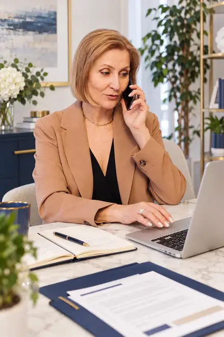 04_Reconnect_With_Leads.webp — A professional following up by phone while reviewing notes beside a laptop. 04_Reconnect_With_Leads.webp — A professional following up by phone while reviewing notes beside a laptop.