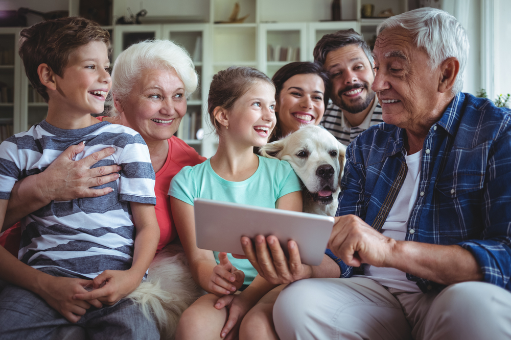 happy multigenerational family using a tablet to read something