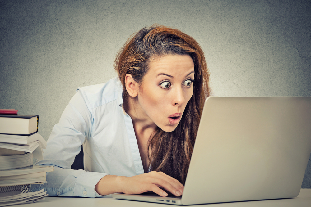 Young woman having an interested reaction to her email on her laptop.