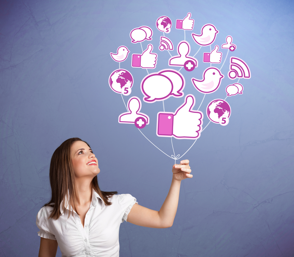 woman holding balloon with social media icons