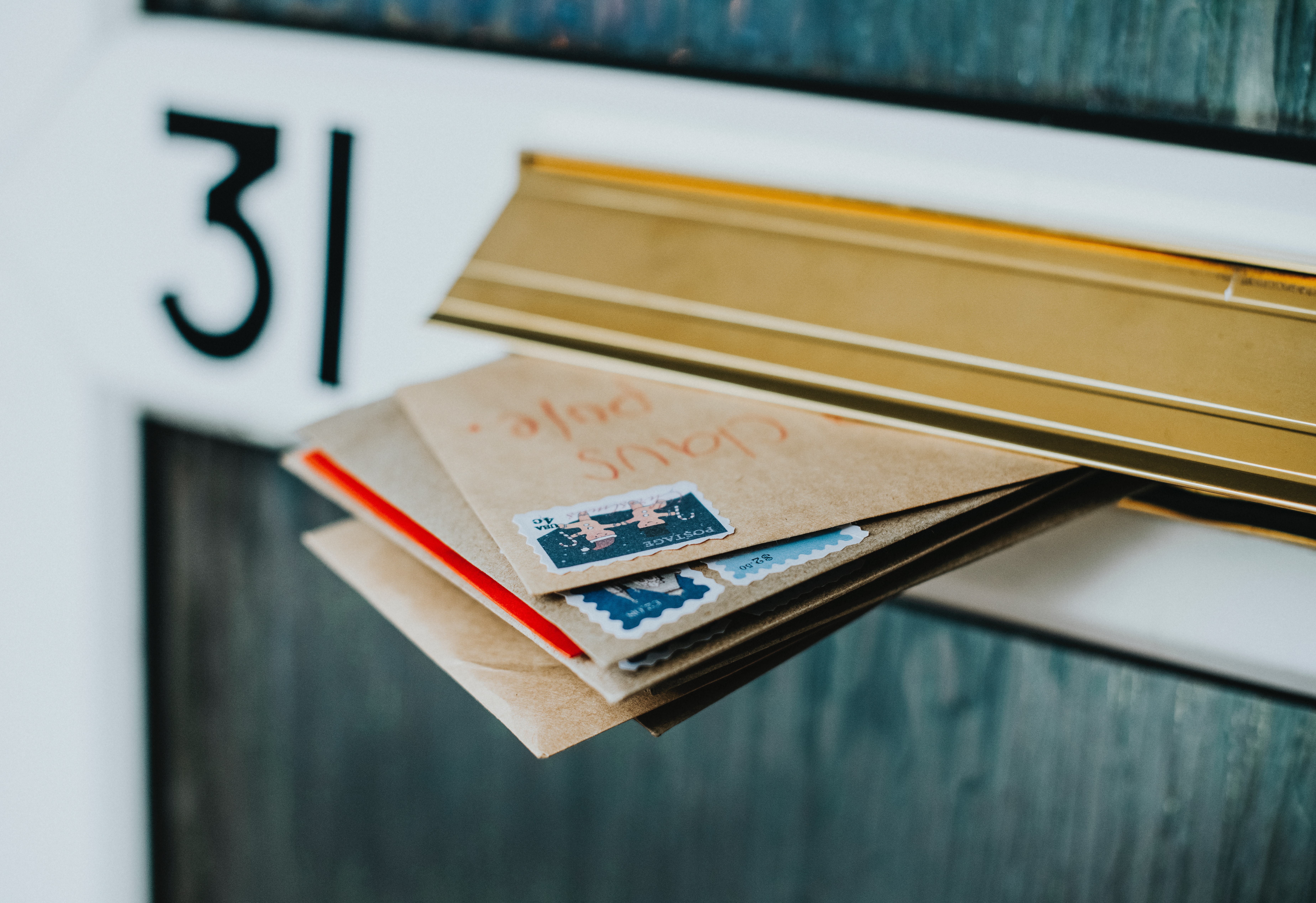 mail sticking out of a letter slot on a door.