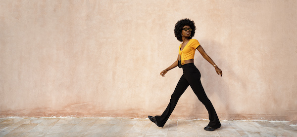 woman walking across the street