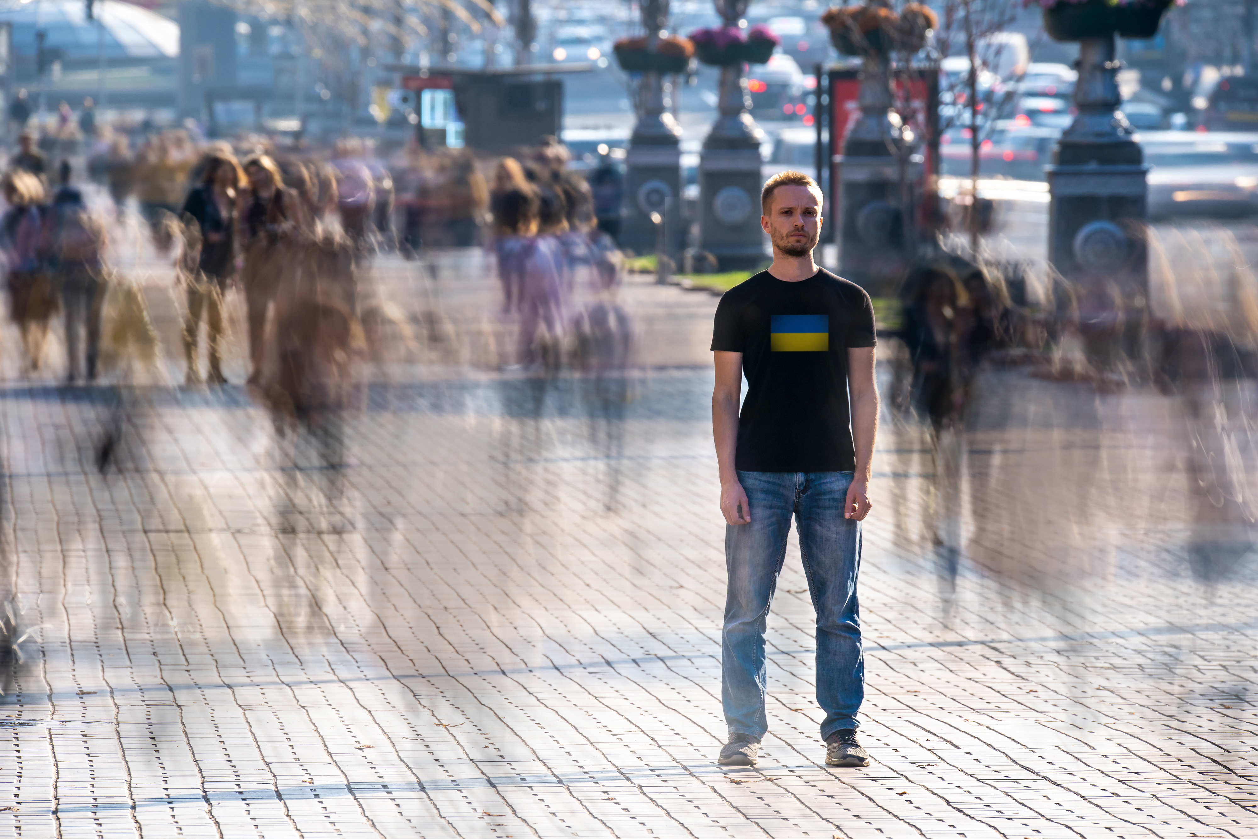 young man alone in a crowd