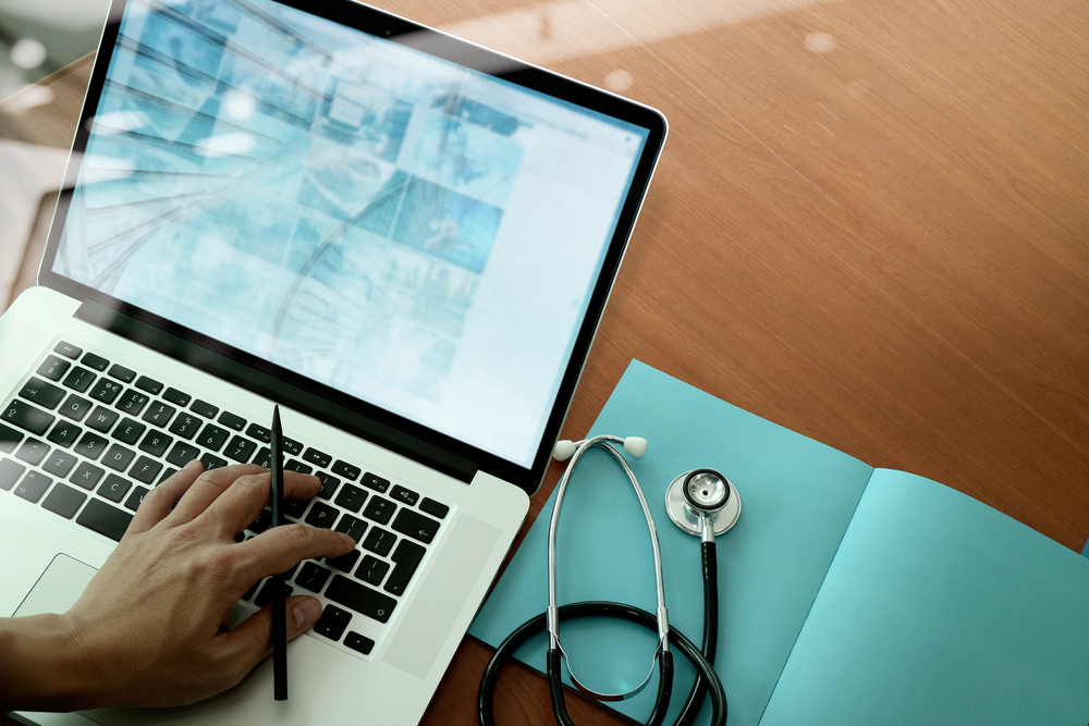 person's hand on laptop keyboard